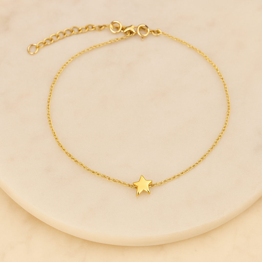 Gold bracelet with a star charm on a beige background