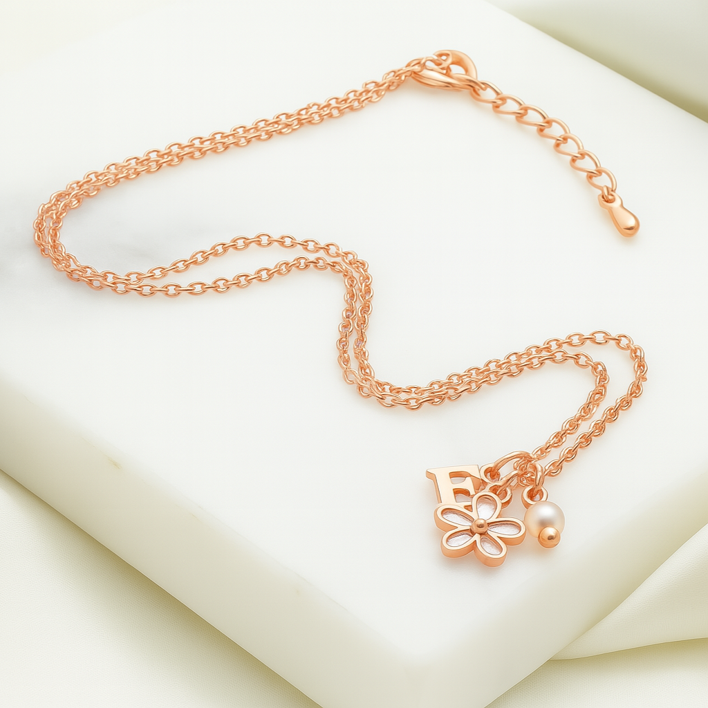 Rose gold necklace with a floral pendant on a soft white background