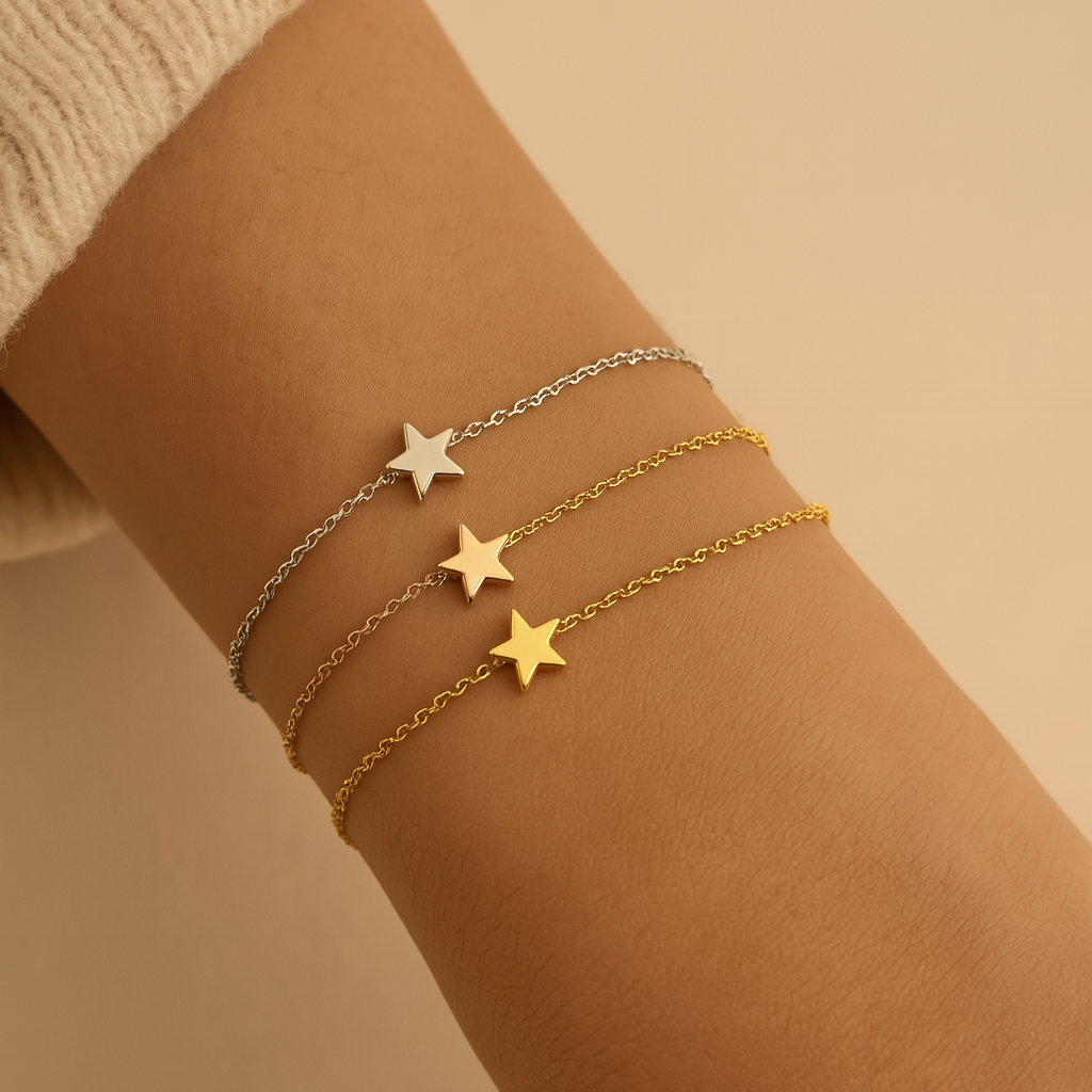 Three star-shaped bracelets on a wrist against a beige background